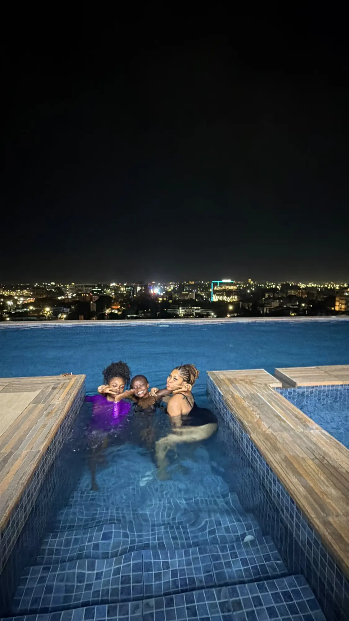Rooftop nights: Pool time with the city lit up below